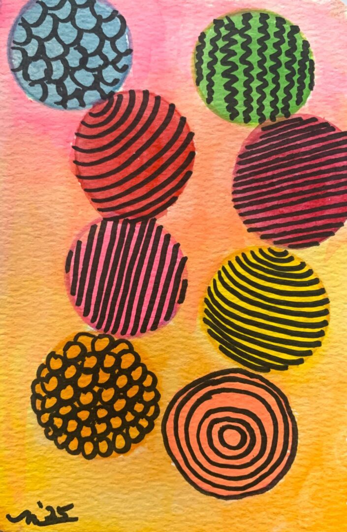 Nine patterned colorful circles on watercolor background