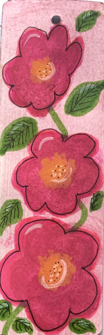 Three pink stylized flowers with green leaves